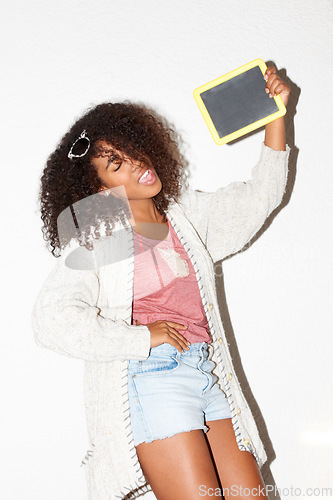 Image of Crazy, cool and a black woman with a blackboard for an announcement, marketing or advertising. Happy, fashion and an African girl with a chalkboard for information, message or a sign on a wall