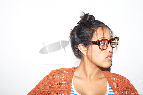 Image of Face, vision and glasses with the attitude of a woman in studio isolated on a white background for style. Fashion, thinking and eyewear with a confident young person on space in a trendy outfit