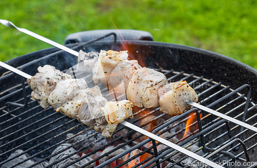 Image of grilling pork skewers