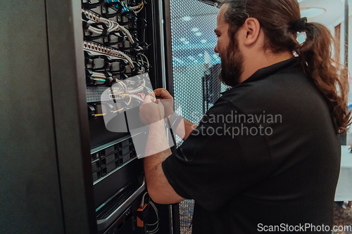 Image of Close up of technician setting up network in server room