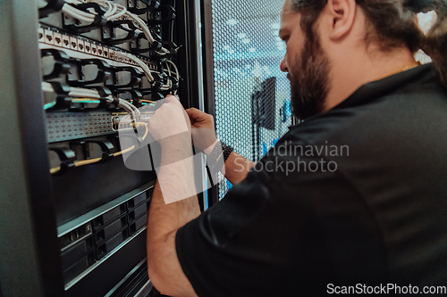 Image of Close up of technician setting up network in server room