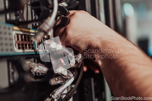 Image of Close up of technician setting up network in server room