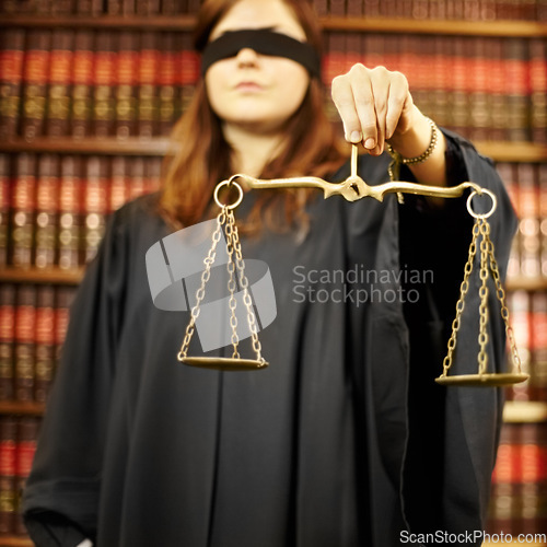 Image of Blindfolded, lawyer and closeup of a scale for justice, court decision or criminal advocate. Office, working or a legal employee holding a tool for judge, notary or legislation in the workplace