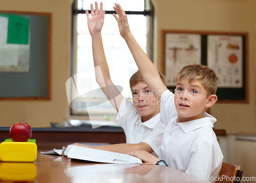 Image of Students, classroom and hands for learning with question, teacher education and studying in kindergarten. Boys, school kids or scholarship with motivation by desk, knowledge test and brainstorming