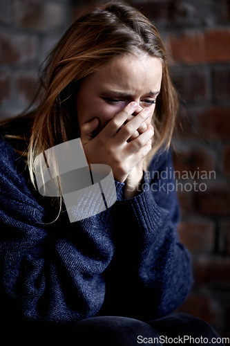 Image of Woman, abuse and crying with hands, scared and alone with fear, hiding and afraid. Toxic relationship, shame or home for physical assault, problem or domestic violence with terror, anxiety or pain