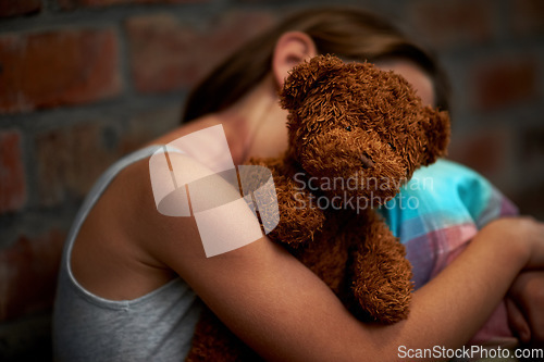 Image of Abuse, girl and child with fear, teddy bear and stress with depression, anxiety and bullying. Person, kid and victim with a toy, home and sad with mental health, crisis and trauma with development