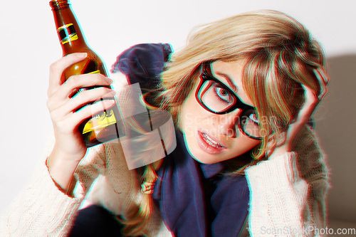 Image of Portrait, fashion and a bottle of beer with a woman in studio isolated on a white background feeling dizzy closeup. Face, alcohol and headache with a young drunk person drinking at a party or event