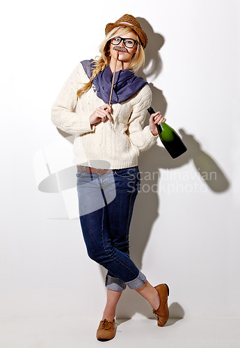 Image of Portrait, woman and holding moustache with champagne for photo or comic on a white background for fun. Funny, alcohol and girl with a prop at an event for crazy, comedy and celebration for a picture