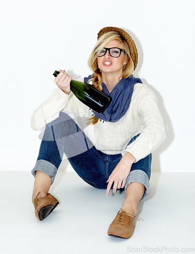 Image of Champagne, drunk or woman on floor with hangover from hipster, rebel or event in studio. Relax, festive or female person drinking alcohol or beverage in bottle for New Year on white background