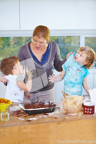 Image of Family, baking and a mother scolding her children for the mess in a home kitchen with naughty boys. Food, cake or ingredients with a woman yelling at her kids while cooking in an untidy apartment
