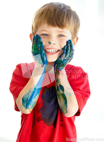 Image of Portrait, smile and paint with a creative boy in studio isolated on a white background for art or education. Face, hands and messy with a happy young child student touching his cheeks in excitement