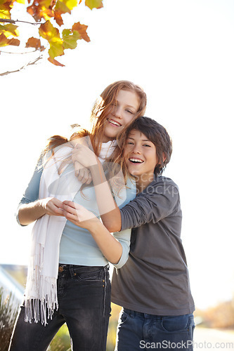 Image of Woman, autumn hug and friends portrait at park with smile and happy from travel, vacation and leaves. Holiday, outdoor and calm female person in New York with freedom and adventure by tree in garden