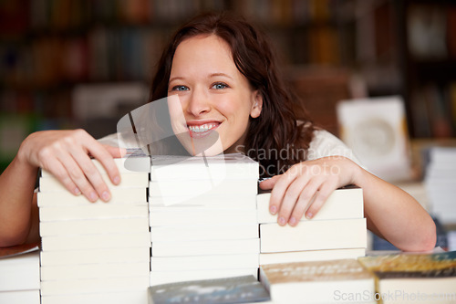 Image of Woman, bookstore business owner and smile in portrait by stack for discount, sale or pride for promotion. Entrepreneur, library and happy for retail deal, literature or knowledge for learning in shop