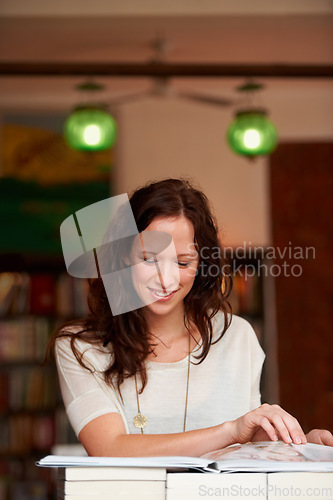 Image of Reading, books and woman in bookstore, library or shop for research, learning and relaxing. Literature, customer and happy person with book for education, information and studying for hobby or fun