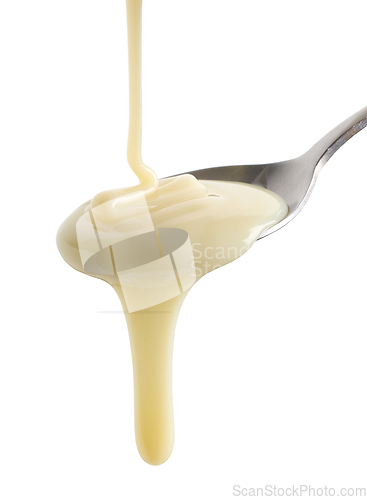Image of condensed milk pouring in spoon