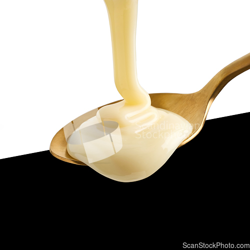 Image of condensed milk pouring into spoon