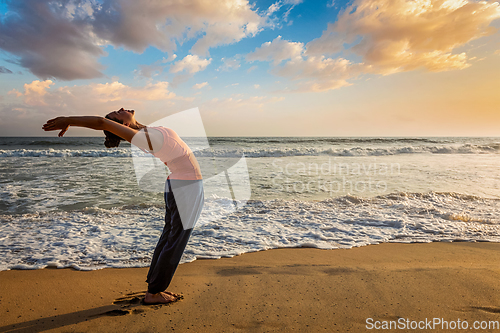 Image of Woman doing yoga Sun salutation Surya Namaskar