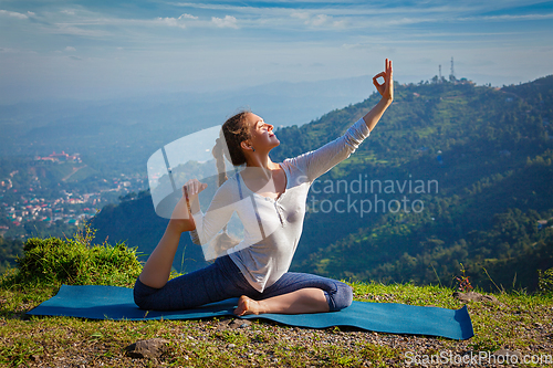 Image of Sorty fit woman doing yoga asana outdoors in mountains