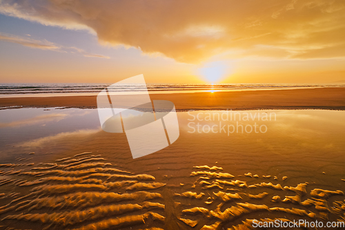 Image of Atlantic ocean sunset with surging waves at Fonte da Telha beach, Portugal