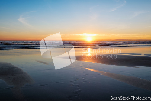 Image of Atlantic ocean sunset with surging waves at Fonte da Telha beach, Portugal