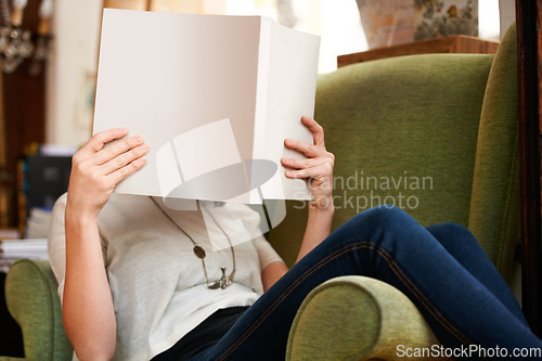 Image of Reading, sofa and person with books in library, bookstore or shop for research, learning and relax. Literature, knowledge and customer with book for education, information and mockup for hobby