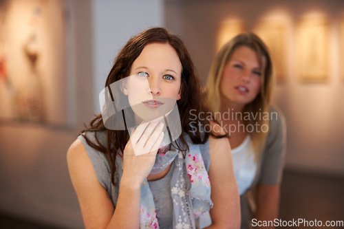 Image of Portrait, exhibition and woman friends in an art gallery together for creative appreciation of culture. Face, thinking and creativity with young people looking at artwork on display in a museum