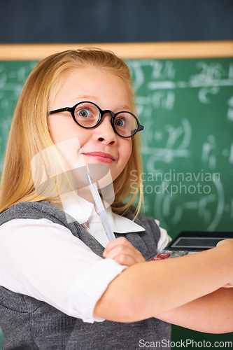 Image of Thinking, math and child student in classroom with idea, solution or brainstorming facial expression. Smile, education and young girl kid with glasses for learning or planning with board in school.