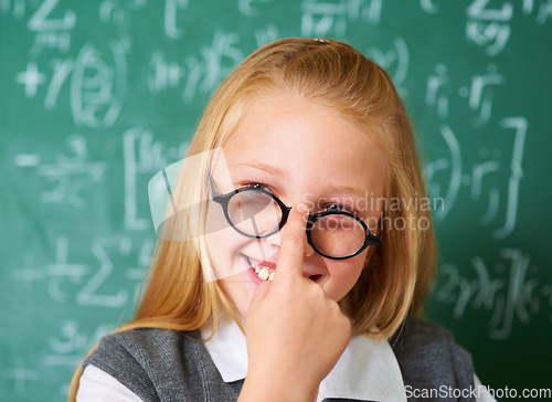 Image of Girl child, student with glasses and chalkboard for learning, education and to start math quiz in classroom. Happy face of smart, intelligent kid with vision, eye care and numbers on board for school