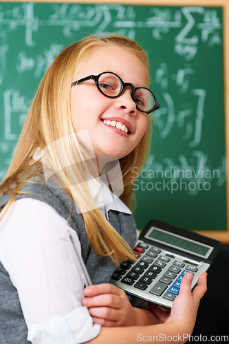 Image of Smile, calculator and child student in classroom for mathematics homework, lesson or test. Learning, education and portrait of happy young girl kid with glasses and maths equipment by board in school