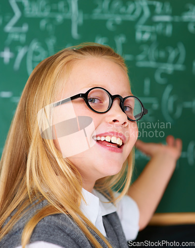 Image of Smile, portrait and child student in classroom with idea, solution or brainstorming facial expression. Happy, education and young girl kid with glasses for learning or planning with board in school.