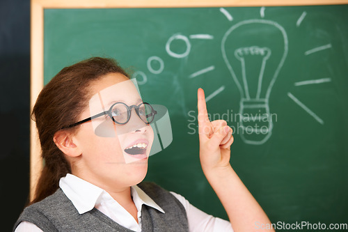 Image of Girl, thinking and light bulb on chalkboard for solution, ideas and wow with education, learning and classroom knowledge. Child, student or school kid with vision, inspiration and lightbulb doodle