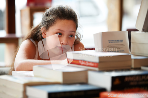 Image of Girl child, books in library and education, story for knowledge or entertainment with customer in bookshop. Learning for development and growth, fiction or literature with young kid in bookstore