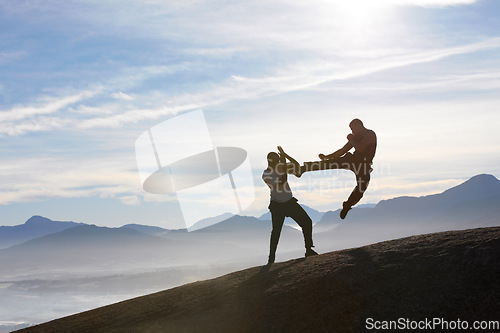 Image of Mountain top, karate men and jump, kick or fitness training in nature for body, speed or power on sky background. Martial arts, taekwondo or MMA friends workout outdoor for cardio, exercise or sports