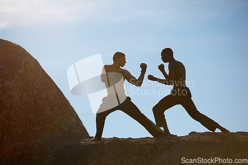 Image of Mountain, fitness and karate men training in nature for body, speed or sparring technique on blue sky background. Martial arts, taekwondo or MMA friends outdoor for morning cardio, exercise or sports