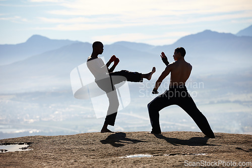 Image of Karate, kick and and fitness men on mountain top for body, speed or performance training. Martial arts, defense or taekwondo workout by MMA friends in nature for morning cardio, exercise or sports