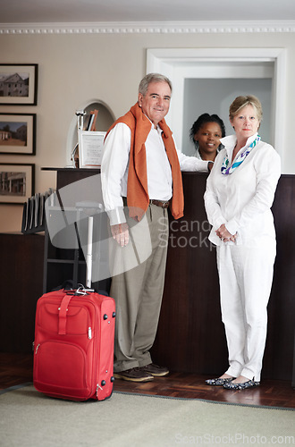 Image of Travel, hotel and senior couple by reception to check in desk for love, anniversary and relax. Retirement, hospitality resort and elderly man and woman with concierge for bonding, holiday or vacation