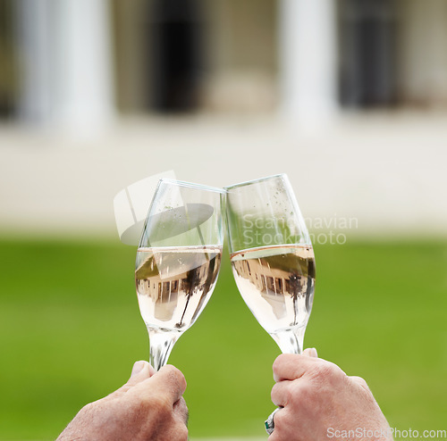 Image of Couple, married and hands with champagne in celebration of anniversary, success or retirement. Mature, man and woman with toast, drink or cheers at hotel for love, romance or quality time in bond