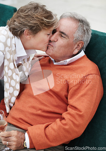 Image of Love, kiss and senior couple in a backyard with champagne for retirement, anniversary or celebration. Trust, gratitude and old people embrace in a yard with care, trust and bond, fun and romance