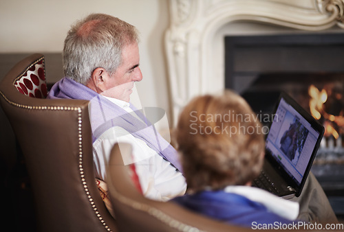 Image of Relax, senior couple with laptop in hotel lounge or restaurant checking social media on retirement vacation. Computer, old man and woman at fireplace in cozy holiday accommodation with online search.