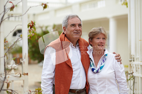 Image of Embrace, smile and old couple outside hotel, villa and love on luxury retirement vacation together. Marriage, travel and romantic holiday accommodation, senior man and woman in courtyard hugging.