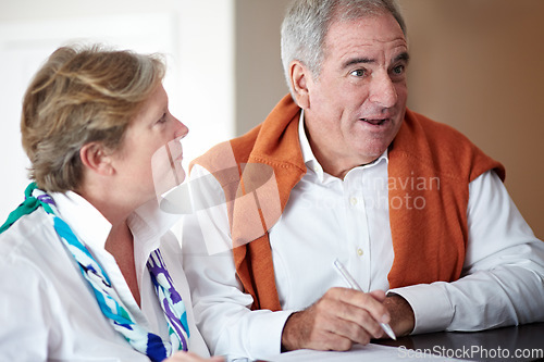 Image of Sign in, hotel and senior couple by reception to check in desk for love, anniversary and relax. Retirement, hospitality resort and elderly man and woman with concierge for travel, holiday or vacation
