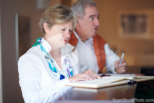 Image of Travel, hotel and elderly couple by reception to check in desk for travel, anniversary and relax. Retirement, hospitality and senior man and woman with concierge for bonding, holiday or vacation