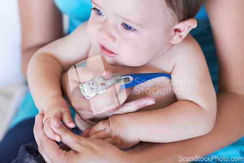 Image of Baby, armpit and thermometer to measure of fever for sick with parent while holding hand in trust. Mother, infant and childcare for health, treatment or test of virus, illness or infection at home