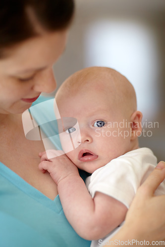 Image of Calm, baby and portrait with mother holding newborn in home for bonding together. Infant, face and mom carrying curious child in arms to relax in house with love, care and support with mommy