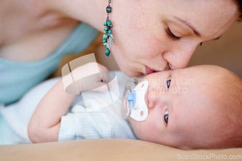 Image of Kiss, love or mother with newborn or baby for care or bonding together to nurture child development. Home, face or single parent mom with infant for trust, growth or safety in family house to relax