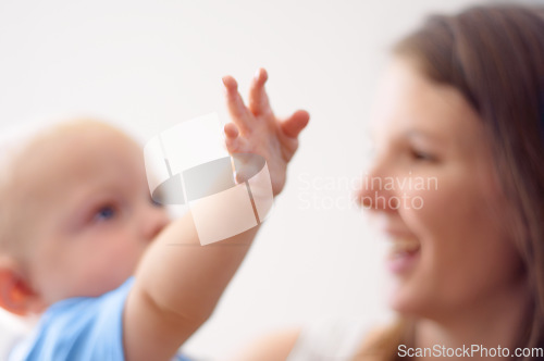 Image of Happy, hand or mom blur with baby for love or bond together to nurture child development. Smile, play or single parent mother with a young newborn for trust, growth or safety in family house to relax