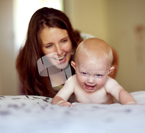 Image of Laughing, playing and a mother with a baby on the bed for bonding, love and care in the morning. Wake up, smile and a mom with a kid or family together in the bedroom of a house for happiness