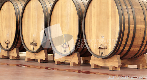 Image of Background, wine production and wood barrel in brewery, alcohol industry and whiskey manufacturing. Liquor, drum container and beer storage in winery cellar, factory and distillery of empty warehouse