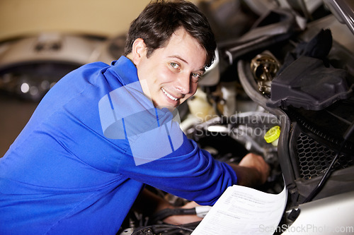 Image of Portrait, happy man and mechanic with document on engine of car, repair or maintenance. Smile, face and technician with paperwork on motor vehicle, auto service or workshop, garage or small business