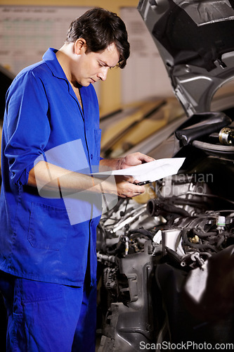 Image of Paperwork, man and mechanic reading at engine of car, repair and maintenance. Checklist, technician and serious person on motor vehicle hood, inspection list and fix transport at auto service garage